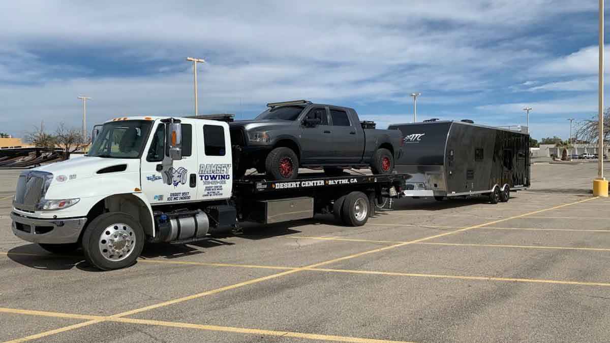 Ramsey Towing hauling pickup truck and trailer