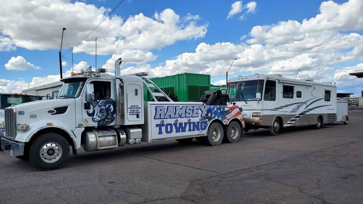 Ramsey Towing hauling recreational vehicle and trailer