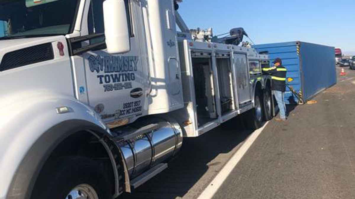 Ramsey Towing worker recovering overturned shipping container