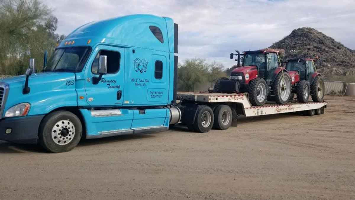 Ramsey Towing truck hauling 2 mudder tractors